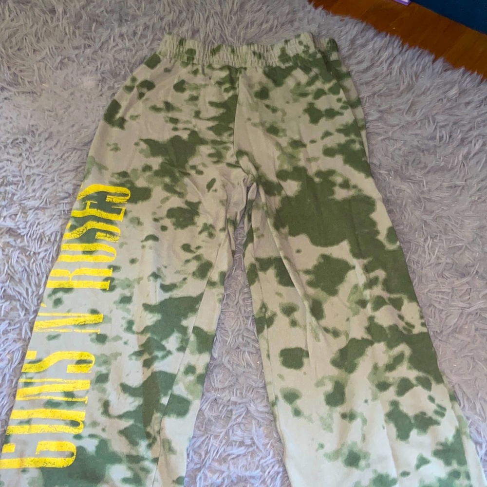 Camo green sweatpants with Guns N’ Roses printed on the right side.